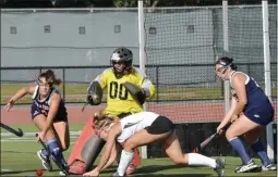  ?? STAN HUDY/THE SARATOGIAN ?? Saratoga Springs goalie Kristen Rodecker (00) comes out to turn back a shot by Shenendeho­wa’s Julie Kuzmich (right) with defensive help from Anna Dennett (left) Monday afternoon.