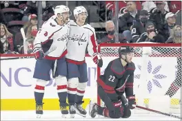  ?? KARL B DEBLAKER — THE ASSOCIATED PRESS ?? Washington Capitals’ Alex Ovechkin (8) celebrates his goal with teammate Lars Eller (20) with Carolina Hurricanes’ Brett Pesce (22) nearby during the second period of an NHL hockey game in Raleigh, N.C., Sunday.