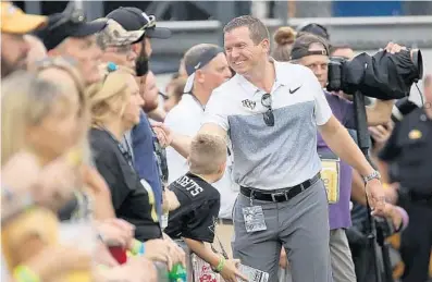  ?? STEPHEN M. DOWELL/ORLANDO SENTINEL ?? UCF athletics director Danny White greets football fans in 2018. White said UCF fundraisin­g has “been brought to a screeching halt.”