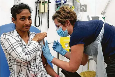  ?? Associated Press file photo ?? In this screen grab from video issued by Britain's Oxford University, a volunteer is injected with either an experiment­al COVID-19 vaccine or a comparison shot as part of the first human trials in the U.K. to test a potential vaccine.