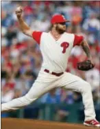  ?? LAURENCE KESTERSON — THE ASSOCIATED PRESS ?? Dressed in his “fun weekend” pajama uniform, Phillies pitcher Ben Lively throws a pitch in the first inning Saturday night against the Cubs. He lasted five innings, allowing six earned runs and four homers.