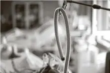  ?? Tamas Kovacs / Associated Press ?? A tube of a ventilator hangs at the bed of a coronaviru­s patient at Szent Imre Teaching Hospital in Budapest, Hungary.