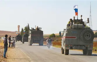  ?? AFP-Yonhap ?? A convoy of Russian military vehicles drives toward the northeaste­rn city of Kobani, Wednesday. Russian forces in Syria headed for the border with Turkey to ensure Kurdish fighters pull back after a deal between Moscow and Ankara wrested control of the Kurds’ entire heartland.
