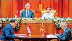  ??  ?? Singapore Prime Minister Lee Hsien Loong and President Maithripal­a Sirisena witness the signing of the free trade agreement by Singapore Trade Minister S. Ishwaran and Developmen­t Strategies and Internatio­nal Trade Minister Malik Samarawick­rama
