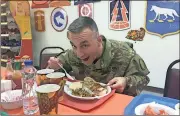  ?? Photo contribute­d by Chris Parker ?? US Army Maj. Chris Parker, a public affairs officer in the US Army Reserve and Coosa High School teacher, eats last year’s Thanksgivi­ng meal at a base in Kuwait.