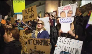  ?? DAVID MCNEW/AFP ?? People protest against the appointmen­t of white nationalis­t alt-right media mogul and former Breitbart News head Steve Bannon as chief White House strategist by president-elect Donald Trump.