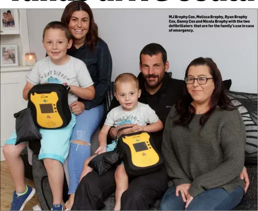  ??  ?? MJ Brophy Cox, Melissa Brophy, Ryan Brophy Cox, Danny Cox and Nicola Brophy with the two defibrilla­tors that are for the family’s use in case of emergency.