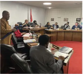  ?? (Pine Bluff Commercial/Byron Tate) ?? Pine Bluff City Council member Ivan Whitfield (standing) prepares to take his seat as a special meeting of the council is about to start on Thursday night.