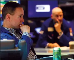  ?? (MICHAEL M. SANTIAGO/GETTY IMAGES/TNS) ?? Traders work on the floor of the New York Stock Exchange during morning trading on April 12, 2022 in New York City.