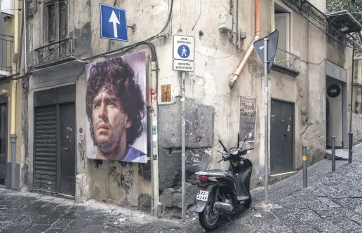  ?? ?? A mural showing Argentinia­n footballer Diego Maradona, on a street in Naples, Italy, Nov. 23, 2021.