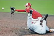  ?? [PHOTO BY BRYAN TERRY, THE OKLAHOMAN] ?? Oklahoma State’s Matt Kroon slides safely into second base as Oklahoma’s Brandon Zaragoza waits for the throw.