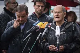  ?? MARIUS BECKER — DPA ?? Armin Laschet, top candidate of the German Christian Democrats, and Olaf Scholz, top candidate of the German Social Democrats, address the media during a press conference in Stolberg on Aug. 3.