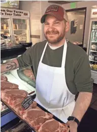  ?? RANGE MEAT CO. KETTLE ?? Kettle Range Meat Company’s Kevin Schwei displays heritage Red Wattle porterhous­e pork chops.