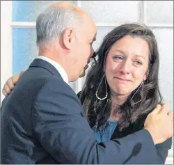  ?? THE CANADIAN PRESS/ANDREW VAUGHAN ?? Carly Sutherland is comforted by Progressiv­e Conservati­ve Leader Jamie Baillie after a news conference at the legislatur­e in Halifax on Thursday. Sutherland’s nine-year-old son, Callum, is severely impacted by autism and the family is having a hard...