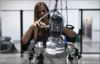  ?? JAE C. HONG — THE ASSOCIATED PRESS ?? Artificial intelligen­ce engineer Jenna Reher works on humanoid robot Figure 01at Figure AI’S test facility in Sunnyvale on Oct. 3. Numerous technology and venture capital firms say they will invest in the startup.