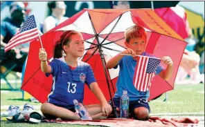  ?? Arkansas Democrat-Gazette/THOMAS METTHE ?? Finley Behring, 9, and her brother, Jeb, 6, wave flags while watching the Women’s World Cup championsh­ip match on Sunday at War Memorial Stadium in Little Rock. More photos are available at www.arkansason­line.com/78wcwatch/