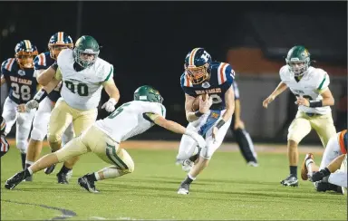  ?? (Special to NWA Democrat-Gazette/David Beach) ?? Carter Hensley (center) of Rogers Heritage runs the ball against Alma on Friday at David Gates Stadium in Rogers.