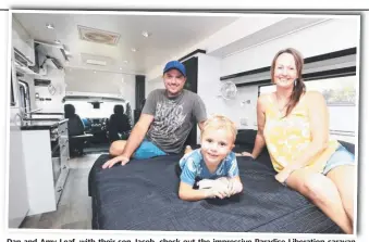  ?? Picture: JASON O’BRIEN ?? Dan and Amy Leaf, with their son Jacob, check out the impressive Paradise Liberation caravan at the Caravan and Outdoor Expo at Carrara.