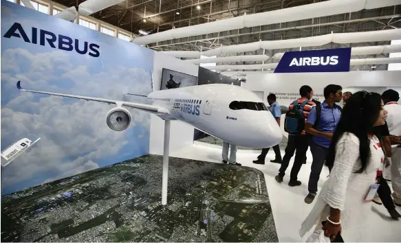 ?? EPA ?? An Airbus stall at the Aero India exhibition in Bengaluru. Airbus posted a 13 per cent decline in fourth-quarter profit, despite revenue increase