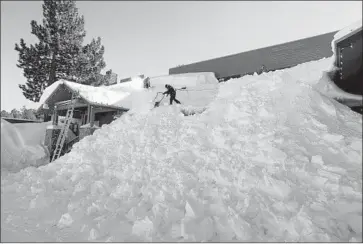  ?? Photograph­s by Allen J. Schaben Los Angeles Times ?? WORKERS SHOVEL snow drifts at a Mammoth Lakes shopping center. Several feet of snow have accumulate­d across the Sierra Nevada this month in one of the most plentiful winters in California in a decade.