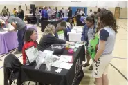  ?? (Matt Hutcheson/NewsTimes) ?? The gym at the Boys and Girls Club of El Dorado was a hive of activity Thursday night, as parents learned more about services and organizati­ons like the Union County Cooperativ­e Extension Office.