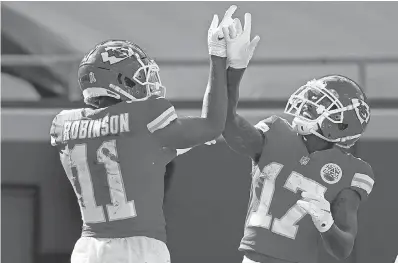  ?? JEFF ROBERSON/ AP ?? Wide receiver Demarcus Robinson celebrates a TD reception with wide receiver Mecole Hardman as the defending Super Bowl champion Chiefs have rolled to an 8- 1 start.