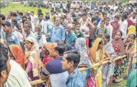  ?? PTI PHOTO ?? People wait to check their names in the NRC draft in Assam’s Tezpur on Monday.