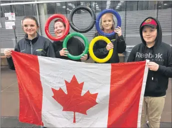  ?? KEVIN ADSHADE/THE NEWS ?? The Olympic rings were on display at the Pictou County Wellness Centre Wednesday. From left are: Emma MacLeod, Daniel Seymour, Jana Cameron and Kalub Melanson.