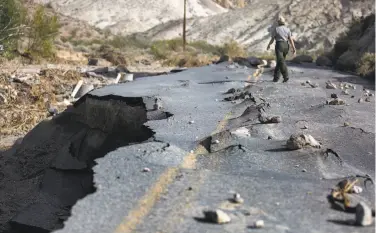  ?? Brian van der Brug / McClatchy-Tribune News Service ?? A 100-yard section of a newly paved Highway 267 in Grapevine Canyon, designed to withstand severe flooding, was torn up after a powerful storm in October triggered a 1,000-year flood event.