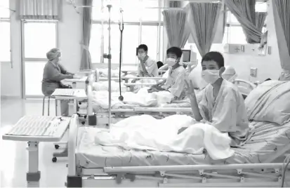  ??  ?? This handout video grab taken from footage released by the Thai government yesterday shows members of the Wild Boars football team being treated at a hospital in Chiang Rai. — AFP