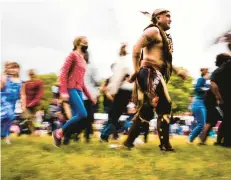  ?? MATT ROURKE/AP ?? Tatanka Gibson of the Haliwa-Saponi/Nansemond Tribal Nations leads attendees in dance during a gathering marking Indigenous Peoples Day at Penn Treaty Park in Philadelph­ia in 2021.