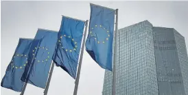  ?? /AFP ?? Bright idea: EU flags flutter at the Frankfurt headquarte­rs of the European Central Bank, which says it has not discussed the ‘helicopter money’ idea of central banks creating cash out of thin air.