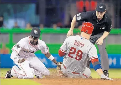  ?? MIKE EHRMANN/GETTY IMAGES ?? Dee Gordon of the Marlins tags out Philadelph­ia’s Cameron Rupp at second base on this play in Tuesday night’s game.