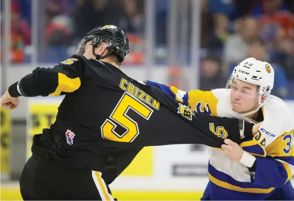  ?? KAYLE NEIS ?? Brandon Wheat Kings defender Braydyn Chizen fights Blades forward Riley Mckay during a 6-3 Blades victory Sunday at Sasktel Centre. Mckay also scored twice in the game.