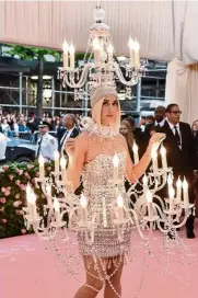  ??  ?? Lighting up the red carpet was Katy Perry – literally. She was dressed as a chandelier, complete with lit bulbs and draped, dangling crystal beading.