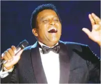 ?? AP PHOTOS/CHARLIE NEIBERGALL ?? Charley Pride performs during his induction into the Country Music Hall of Fame at the Country Music Associatio­n Awards show at the Grand Ole Opry House in Nashville in 2000. Pride, the first Black member of the Country Music Hall of Fame, died Saturday at age 86 from Covid-19.