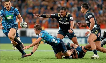  ?? PHOTO: GETTY IMAGES ?? Sonny Bill Williams, right, charges on to the ball for the Blues against the Highlander­s in the first full round of Super Rugby last weekend.