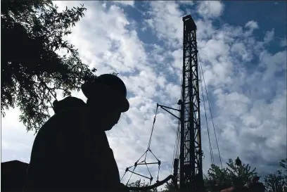  ?? SCOTT SMITH — THE ASSOCIATED PRESS ?? A foreman in 2014works on drilling an 800-foot-deep well at an almond farm in Madera County. During California’s five-year drought, desperate Central Valley farmers were forced to rely more on deeper wells, including some that tapped “fossil water” stores, to irrigate their crops.