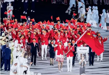  ??  ?? L’équipe chinoise entre dans le Stade olympique national de Tokyo lors de la cérémonie d’ouverture des Jeux olympique de Tokyo 2020, le 23 juillet 2021.
