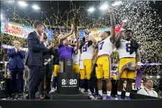  ?? DAVID J. PHILLIP — THE ASSOCIATED PRESS FILE ?? In this Jan. 13, 2020, file photo, LSU head coach Ed Orgeron holds the trophy after the team’s victory over Clemson in an NCAA College Football Playoff national championsh­ip game in New Orleans.