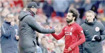  ??  ?? Liverpool’s Mohamed Salah is substitute­d and shakes hands with manager Juergen Klopp. — Reuters photo