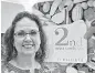  ?? [PHOTO BY CHRIS LANDSBERGE­R, THE ?? Teresa Wall, owner of 42nd Street Candy Co., poses for a photo with her new signage inside Balliets, where she will reopen her store in Oklahoma City.