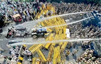  ?? —PTI ?? Police use water cannons to disperse farmers protesting at Delhi-UP border during 'Kisan Kranti Padyatra'.