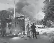  ?? GWEN FILOSA FLKeysNews.com ?? Key West firefighte­rs surround a raging house fire on Wednesday. No injuries were reported.