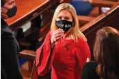  ?? ERIN SCOTT/POOL VIA AP ?? Rep. Marjorie Taylor Greene, R-Ga.. arrives on the floor of the House to take her oath of office on opening day of the 117th Congress at the U.S. Capitol in Washington on Jan. 3.