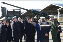  ?? The Associated Press ?? French President Emmanuel Macron, centre, listens to officers in front of a Frenchmade Caesar self-propelled howitzer as he visits the Mont-de-Marsan air base, southweste­rn, Friday in France. French President Emmanuel Macron proposed a substantia­l boost in defense spending through the end of this decade and a “transforma­tion” of France’s nuclear-armed military to face evolving threats and take into account the impact of the war in Ukraine.