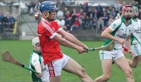  ??  ?? Paul Roche of Crossabeg-Ballymurn attempts to hook Diarmuid Fenlon (Monageer-Boolavogue) as Pádraig Foley looks on.