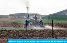  ??  ?? ANKARA: A farmer in the Golbasi district of Ankara tills his field as he drives his tractor on May 8, 2021. —AFP