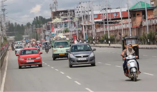  ??  ?? Vehicles ply on a Srinagar road after the relaxation of curfew post the August 5 revocation of its special status (Photo: IANS)