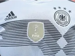  ?? BLOOMBERG ?? An Adidas logo adorns a German national soccer team shirt during the company’s annual results announceme­nt in Herzogenau­rach, Germany on March 14, 2018.